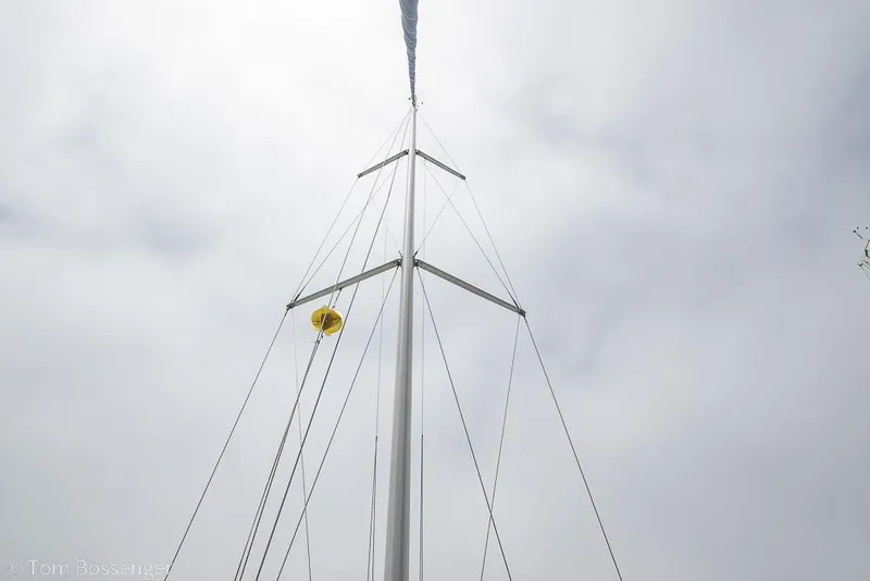 Slide: The Image of Mast of 1999 Hunter 340 sailboat against cloudy sky, featuring rigging and yellow buoy. - 35