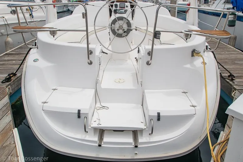 Slide: The Image of 1999 Hunter 340 sailboat cockpit with steering wheel, docked at marina. - 36