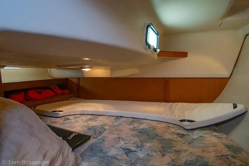 Slide: The Image of Cozy cabin interior of a 1999 Hunter 340 sailboat with bedding and porthole. - 19