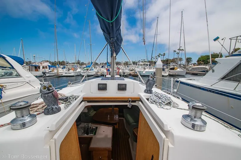 Slide: The Image of Sailboat Hunter 340, 1999 model, docked in a marina with clear blue skies. - 27