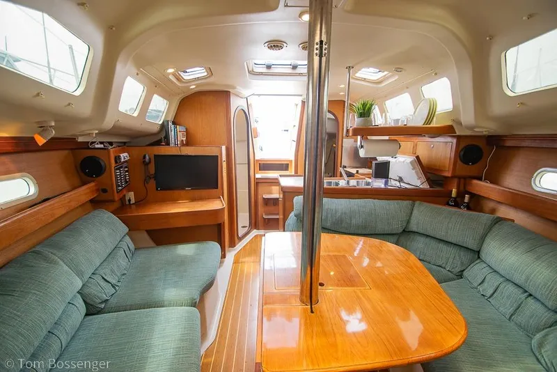 Slide: The Image of Interior of a 1999 Hunter 340 sailboat with cozy seating and wooden finishes. - 16