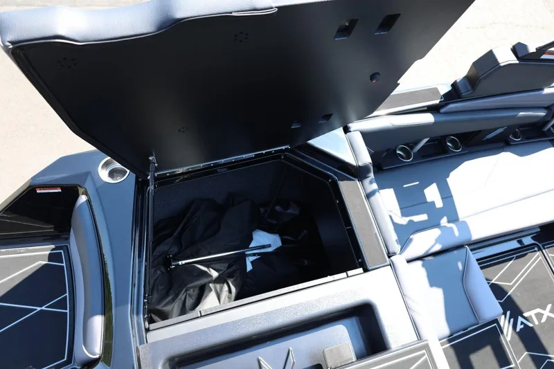 Slide: The Image of The image shows the storage compartment of a 2027 ATX Surf Boats 22 Type-S with an open lid. - 21