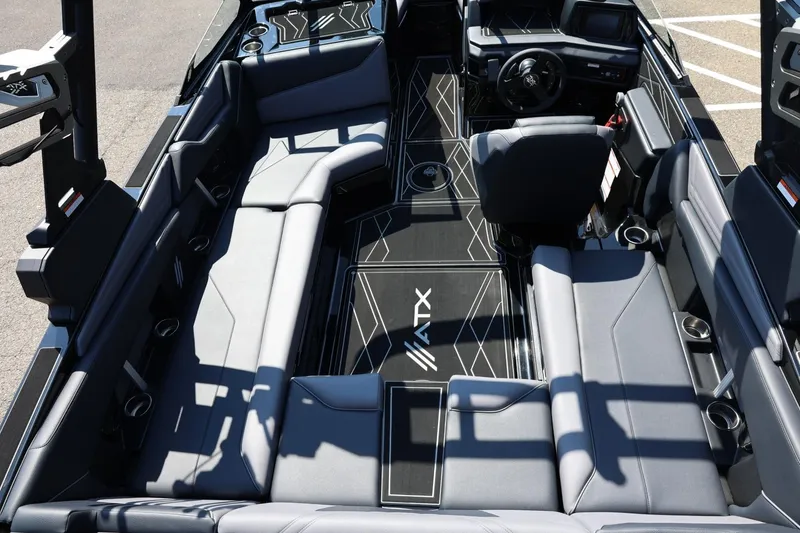 Slide: The Image of The image shows the interior of a 2027 ATX Surf Boats 22 Type-S with gray upholstery and modern design. - 22