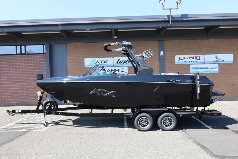 The Image of A 2027 ATX Surf Boat 22 Type-S on a trailer in front of a building. - 1