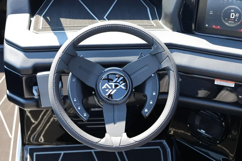 Slide: The Image of The image shows the steering wheel of a 2027 ATX Surf Boats 22 Type-S with a modern design. - 39