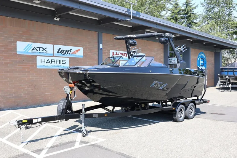 Slide: The Image of A black 2027 ATX Surf Boat 22 Type-S on a trailer in front of a building. - 14