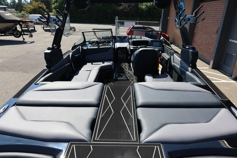 Slide: The Image of The image shows the interior of a 2027 ATX Surf Boats 22 Type-S. It features stylish padded seating and a modern dashboard. - 18