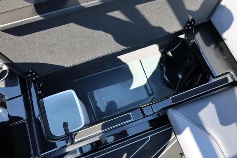 Slide: The Image of An open storage compartment on a 2027 ATX Surf Boat 22 Type-S, featuring a white container. - 30