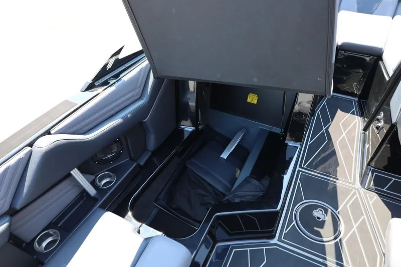 Slide: The Image of The image shows the interior of a 2027 ATX Surf Boats 22 Type-S with an open storage compartment. - 32