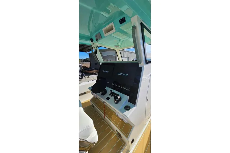Slide: The Image of 2025 Insetta 35IFC boat cockpit with Garmin navigation system and modern controls. - 8