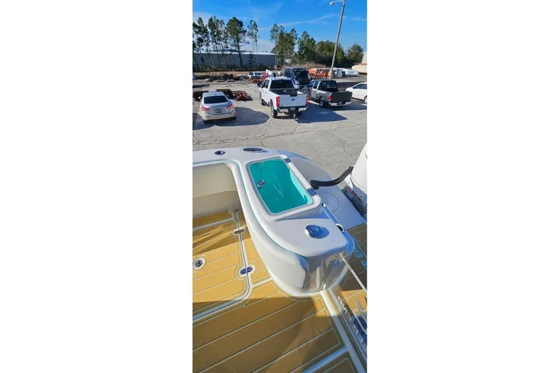 Slide: The Image of 2025 Insetta 35IFC boat deck with seating and storage, parked in a lot. - 15