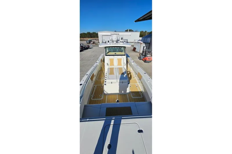Slide: The Image of 2025 Insetta 35IFC boat with spacious deck and modern design in a marina setting. - 4