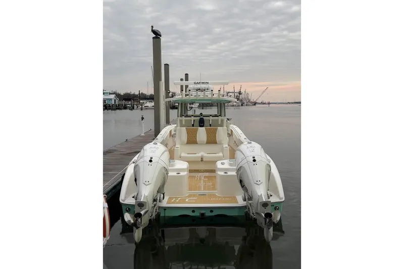 Slide: The Image of 2025 Insetta 35IFC boat docked at marina, featuring twin engines and sleek design. - 1
