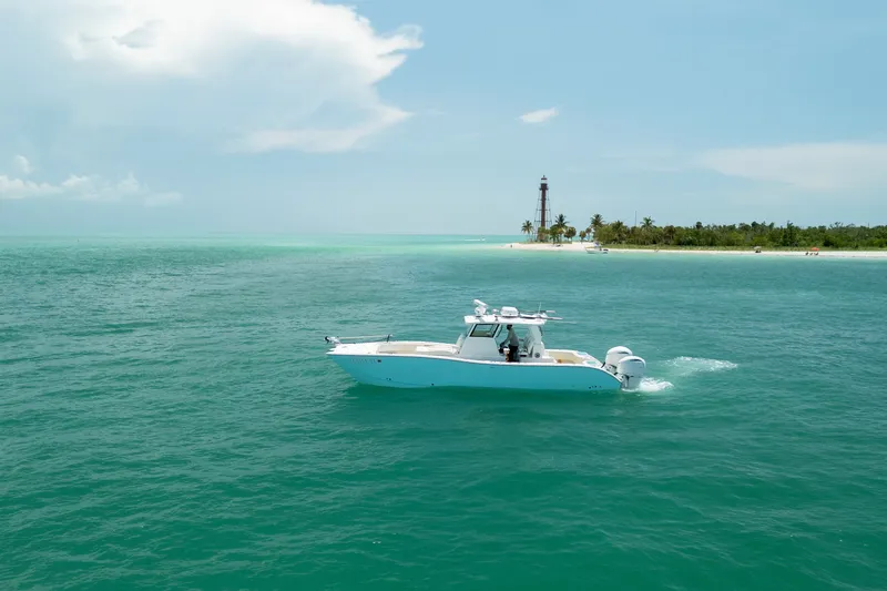 Slide: The Image of 2025 Insetta 35IFC boat cruising near a tropical island with a lighthouse. - 5