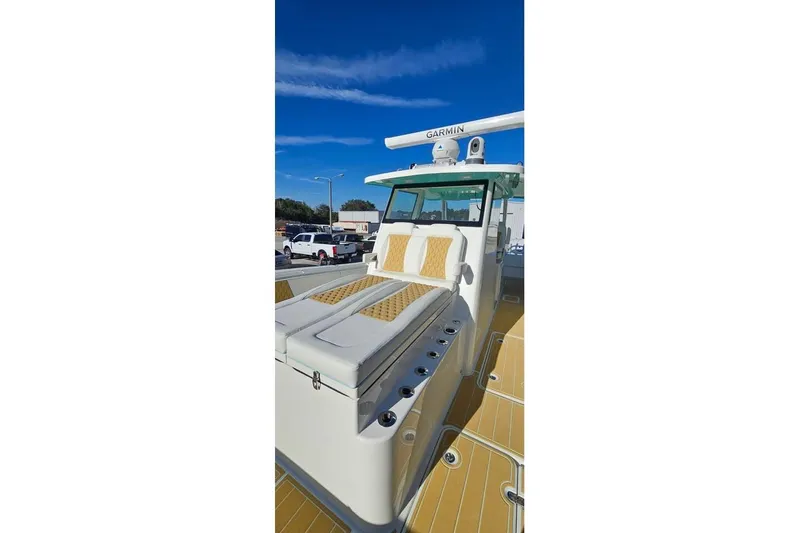 Slide: The Image of 2025 Insetta 35IFC boat with cushioned seating and Garmin equipment under a clear blue sky. - 5