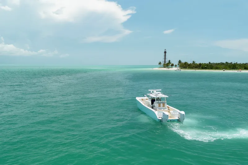 Slide: The Image of 2025 Insetta 35IFC boat cruising near a tropical island with a lighthouse. - 4