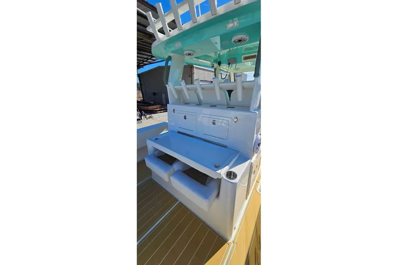 Slide: The Image of 2025 Insetta 35IFC boat interior with storage compartments and rod holders. - 13