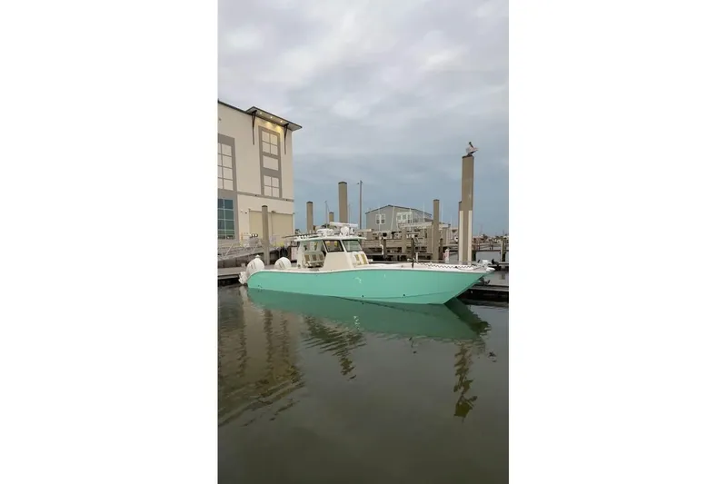 The Image of 2025 Insetta 35IFC boat docked at marina, calm water, overcast sky. - 0