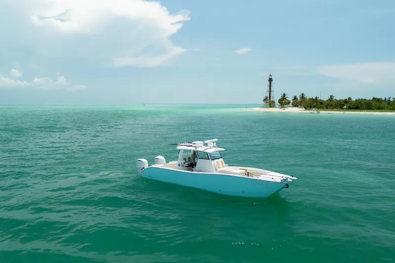 Slide: The Image of 2025 Insetta 35IFC boat cruising near tropical island with lighthouse in turquoise waters. - 3
