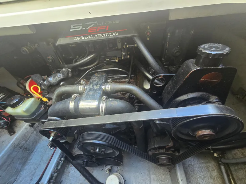 Slide: The Image of The engine compartment of a 1998 Doral 250 SC shows a 5.7-liter EFI engine with digital ignition. - 16