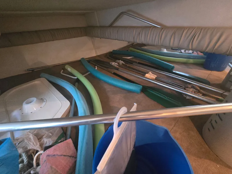 Slide: The Image of The interior of a 1998 Doral 250 SC showing various equipment and pool noodles. - 15