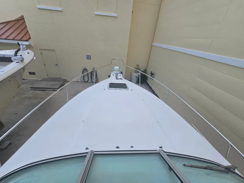 Slide: The Image of The image shows the foredeck of a 1998 Doral 250 SC boat, situated in a narrow area. - 7