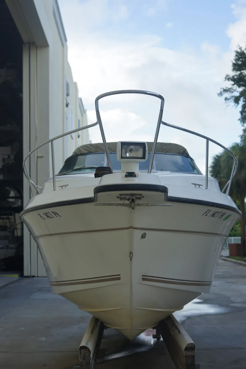 Slide: The Image of A 1998 Doral 250 SC boat on a trailer outside a storage facility. - 2