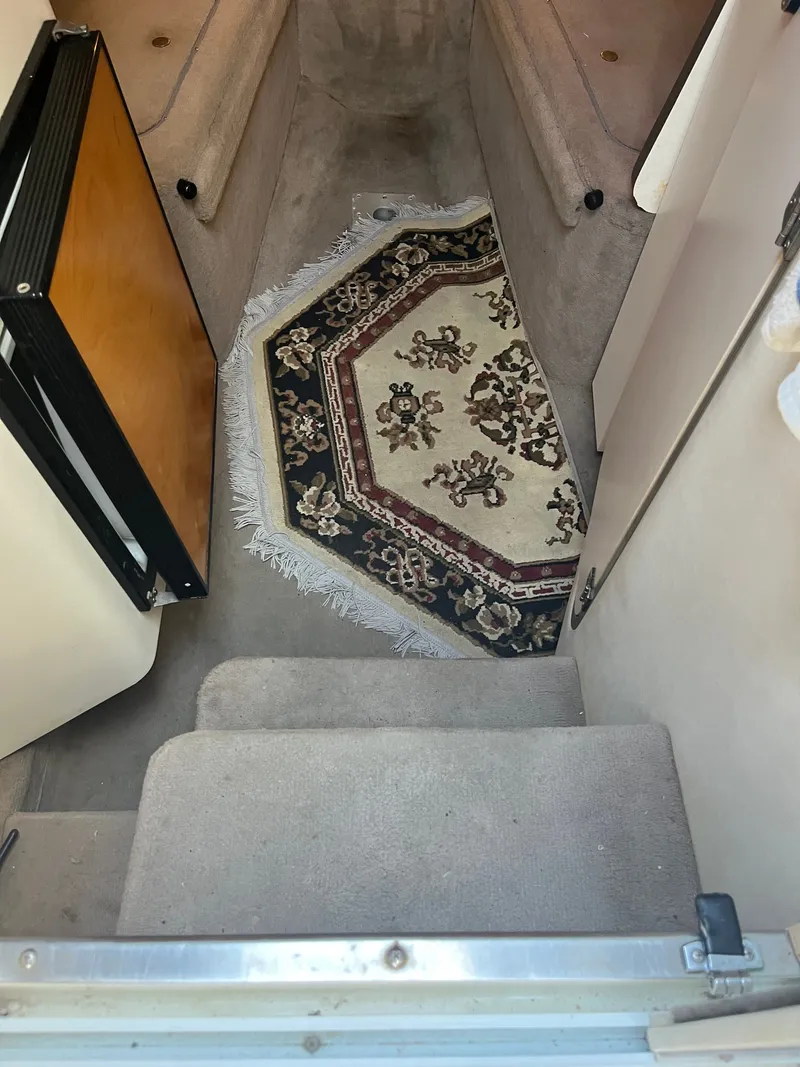 Slide: The Image of The boat's interior features a small rug on the floor and a mini fridge door. - 9