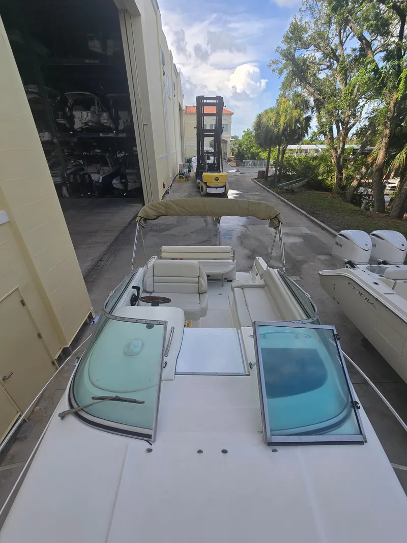 Slide: The Image of A 1998 Doral 250 SC in a storage area. It features an open cockpit and a canopy. - 6