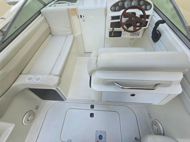 Slide: The Image of The image shows the cockpit of a 1998 Doral 250 SC boat with beige seating and a helm station. - 5