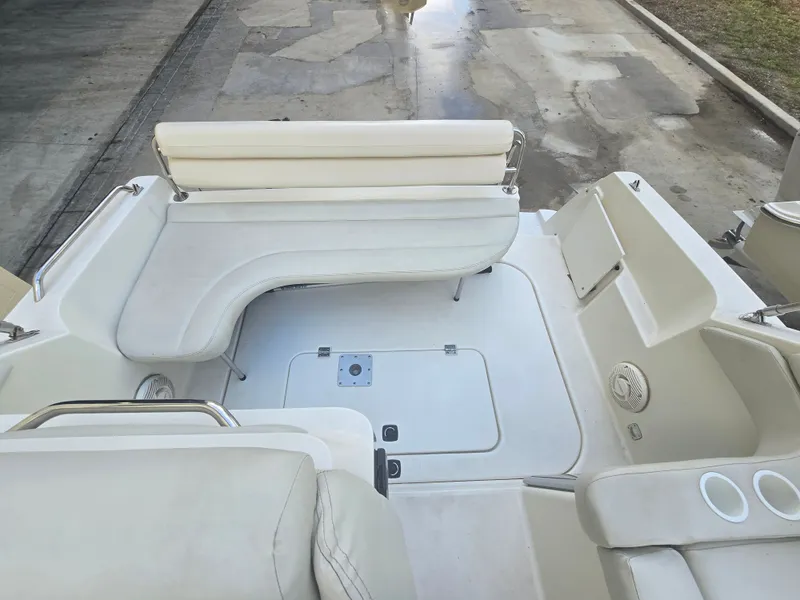 Slide: The Image of The image shows the cockpit of a 1998 Doral 250 SC boat with white upholstery. - 4