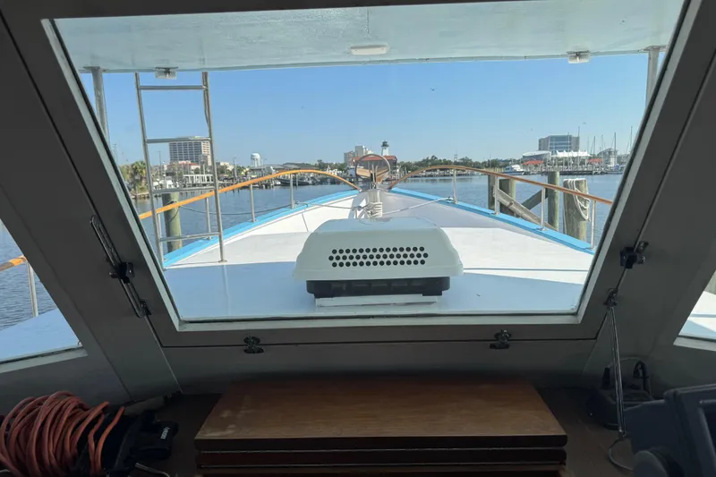Slide: The Image of View from inside a 1985 custom Bill Holland trawler, overlooking a marina. - 16