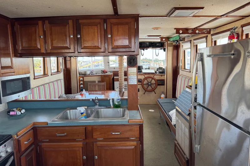 Slide: The Image of Interior of a 1985 custom Bill Holland trawler with kitchen and steering wheel. - 19
