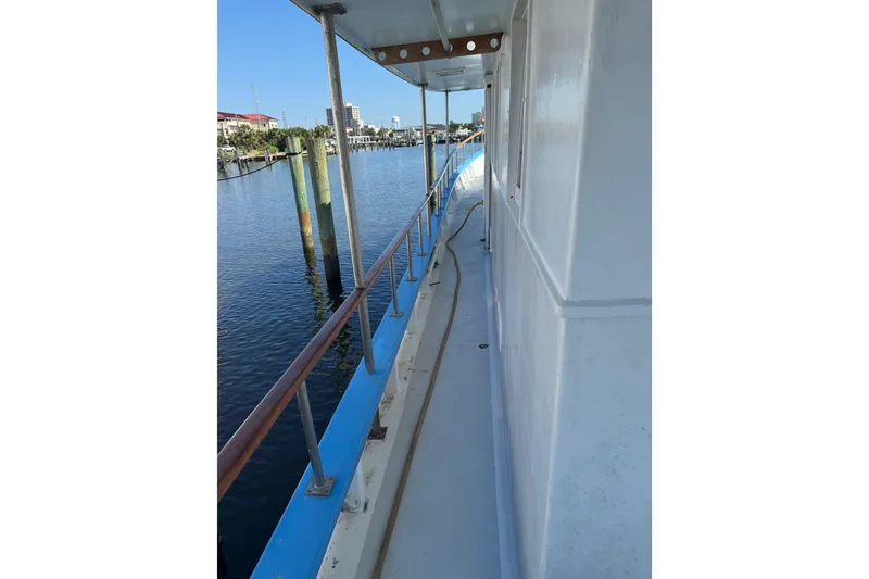 Slide: The Image of Side view of a 1985 custom Bill Holland trawler docked at a marina. - 6
