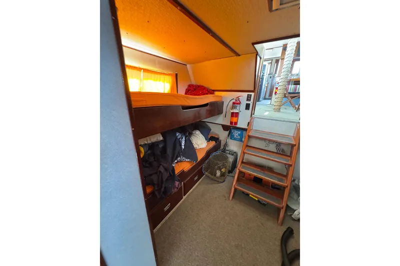 Slide: The Image of Interior of 1985 custom Bill Holland trawler with bunk beds and wooden stairs. - 13