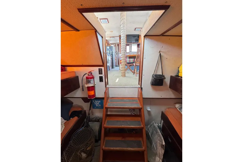 Slide: The Image of Interior of 1985 custom Bill Holland trawler with wooden stairs and cozy cabin features. - 12