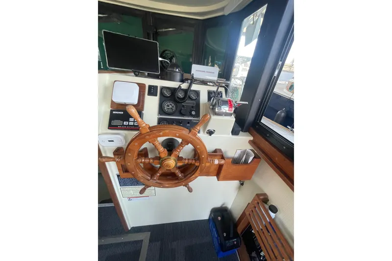 Slide: The Image of Interior helm of 1992 Camano Troll Sedan 31 with wooden steering wheel and navigation instruments. - 7