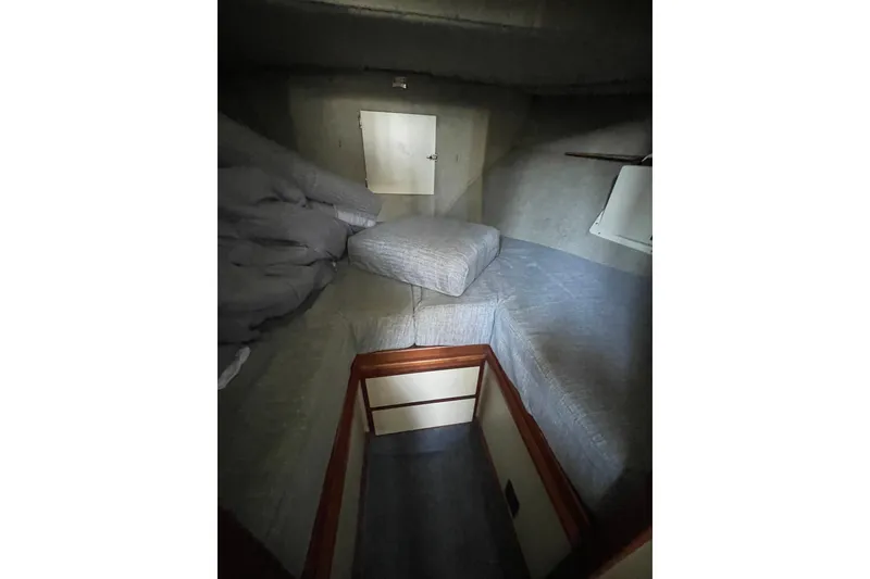 Slide: The Image of Cozy cabin interior of 1992 Camano Troll Sedan 31 boat with gray bedding. - 16