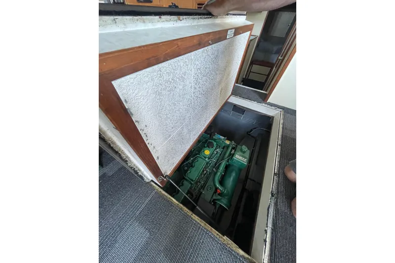 Slide: The Image of Engine compartment of a 1992 Camano Troll Sedan 31 boat, with visible green engine. - 19