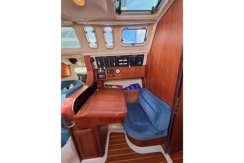 Slide: The Image of Interior of a 1997 Hunter 430 sailboat with navigation station and seating. - 36