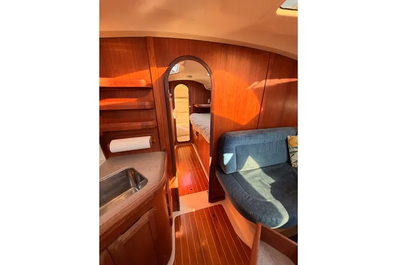 Slide: The Image of Interior of a 1997 Hunter 430 sailboat with wood finish and cozy seating area. - 50