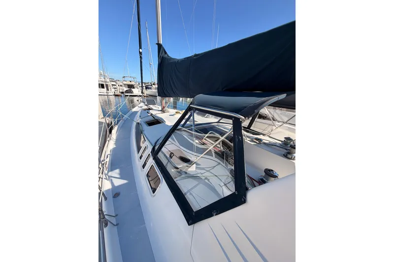 Slide: The Image of Sailboat deck view of 1997 Hunter 430, featuring sleek design and marina backdrop. - 16