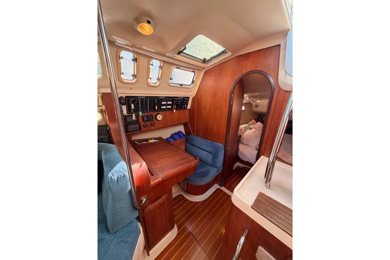 Slide: The Image of Interior of a 1997 Hunter 430 sailboat with wood paneling and navigation station. - 35