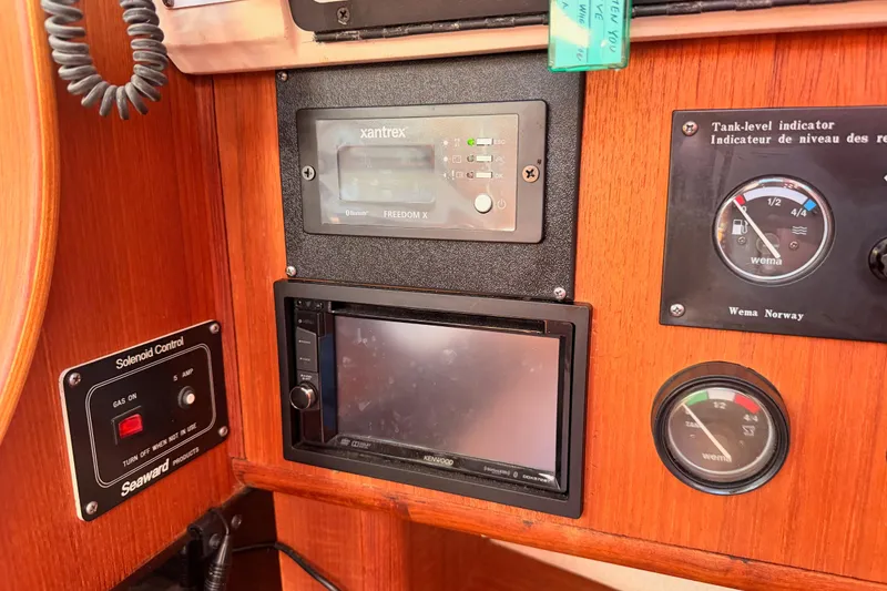 Slide: The Image of Control panel of a 1997 Hunter 430 sailboat with gauges and electronic displays. - 38