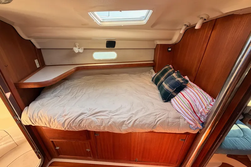 Slide: The Image of Cozy cabin interior of a 1997 Hunter 430 sailboat with a comfortable bed and pillows. - 56