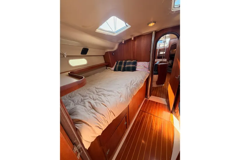 Slide: The Image of Cozy cabin interior of 1997 Hunter 430 sailboat with wooden flooring and skylight. - 63