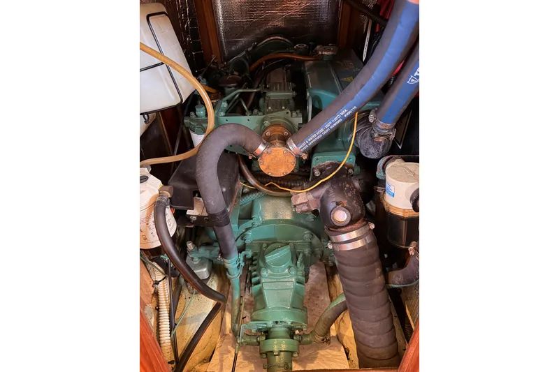 Slide: The Image of Engine compartment of a 1997 Hunter 430 sailboat, featuring hoses and components. - 89