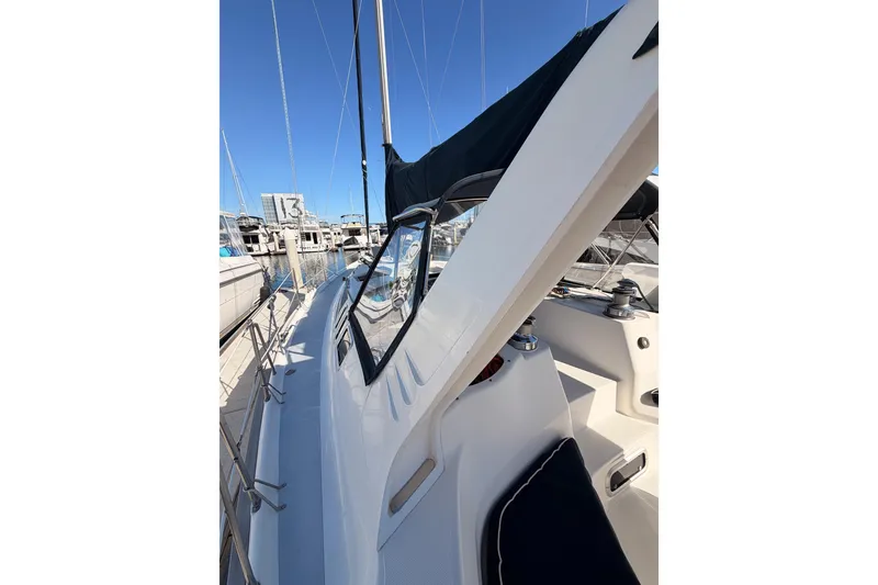 Slide: The Image of 1997 Hunter 430 sailboat docked at marina, showcasing sleek deck design. - 15