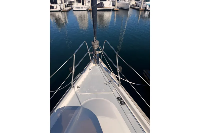 Slide: The Image of Bow view of a 1997 Hunter 430 sailboat docked in a marina. - 20