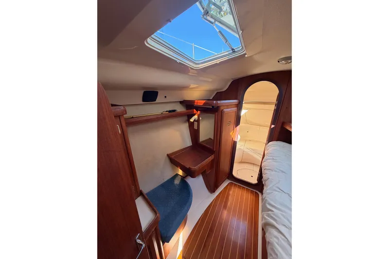 Slide: The Image of Interior of 1997 Hunter 430 sailboat with wooden finishes and skylight. - 53